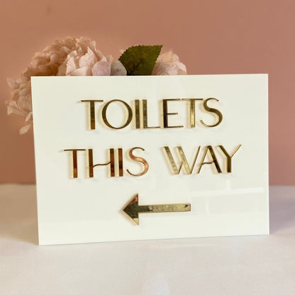 A5 Directional Sign made in white gloss acrylic and 3d gold mirror text.