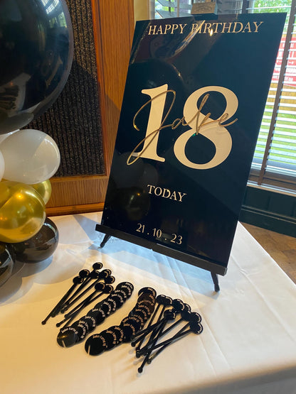 18th birthday welcome sign with matching decorative items on a table