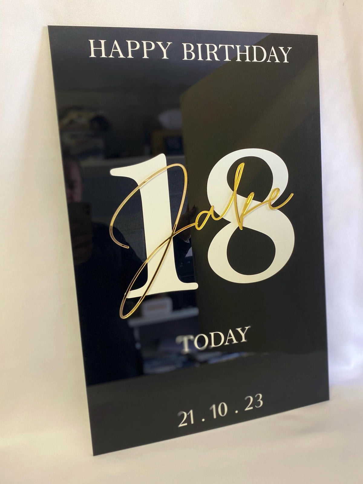 Black Acrylic Birthday Welcome Sign with gold text 'Happy Birthday Jake 18 Today' on a white background