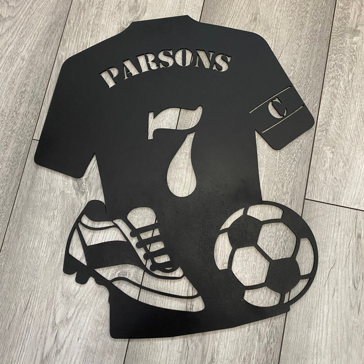 Custom Bedroom Wall art in the shape of a football shirt with cut out ball and boots.