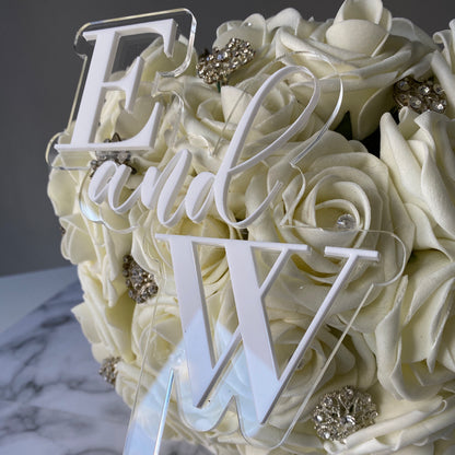 Wedding cake topper with the couples initials in white acrylic
