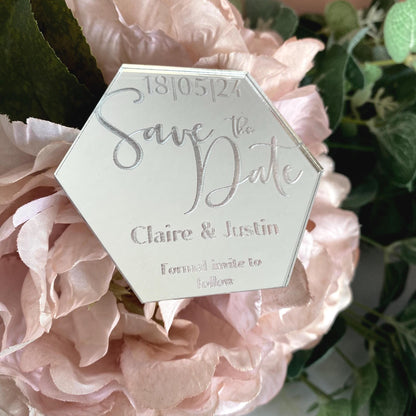 Hexagonal 'Save the Date' card on pink flowers