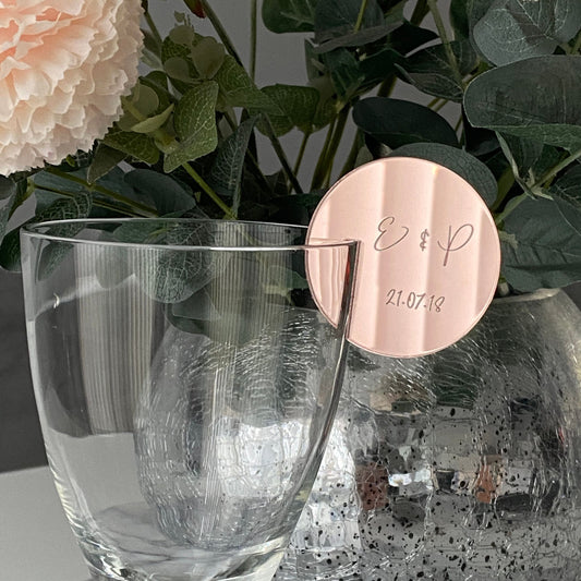 Engraved Wedding Drinks Place Card slotted on to a wine glass in Rose Gold Acrylci