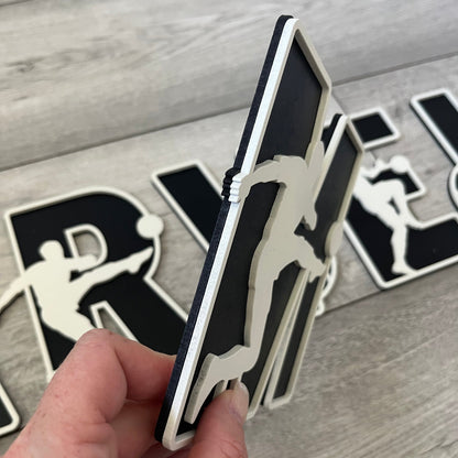 Side view of wooden football letter