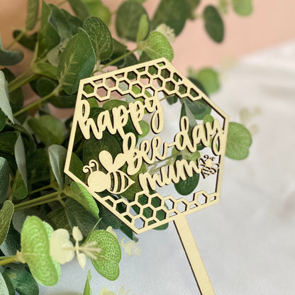 Wooden Cake Topper in a hexagon shape with honeycomb and bee details.