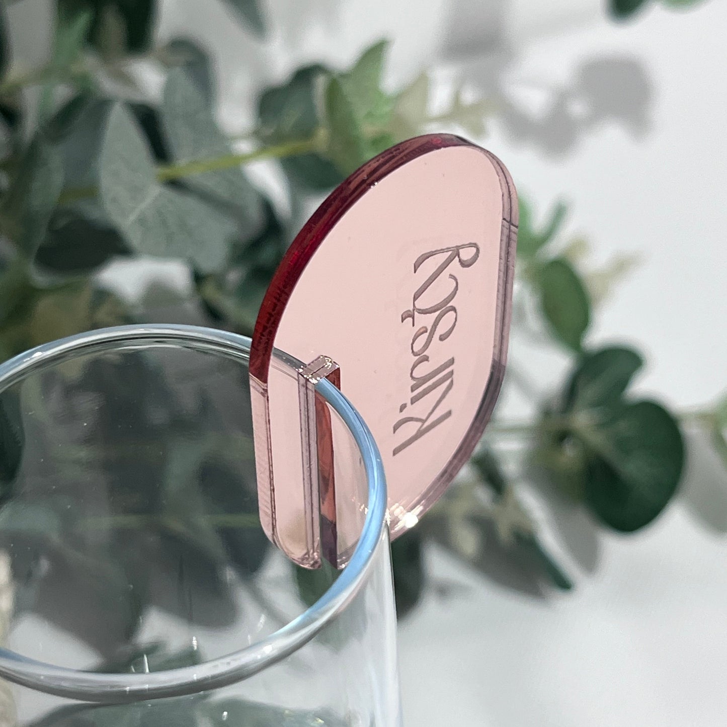 Wedding Place Card that slots on to a wine glass in rose gold mirror acrylic with the name Kirsty engraved in to it