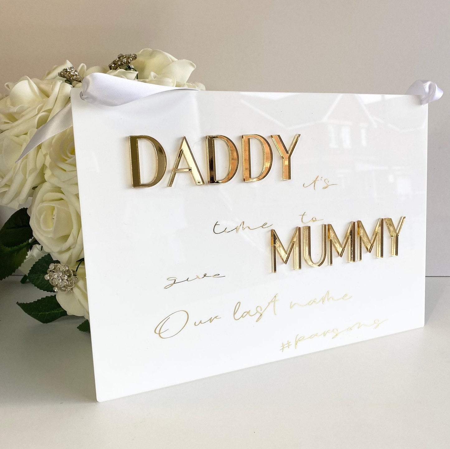 Page boy sign in white acrylic saying in gold text daddy it's time to give mummy  our last name