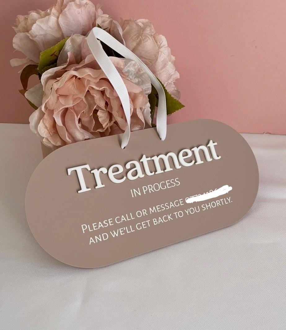 Acrylic Sign with 'Treatment In Progress' message and pink flowers on a light pink background