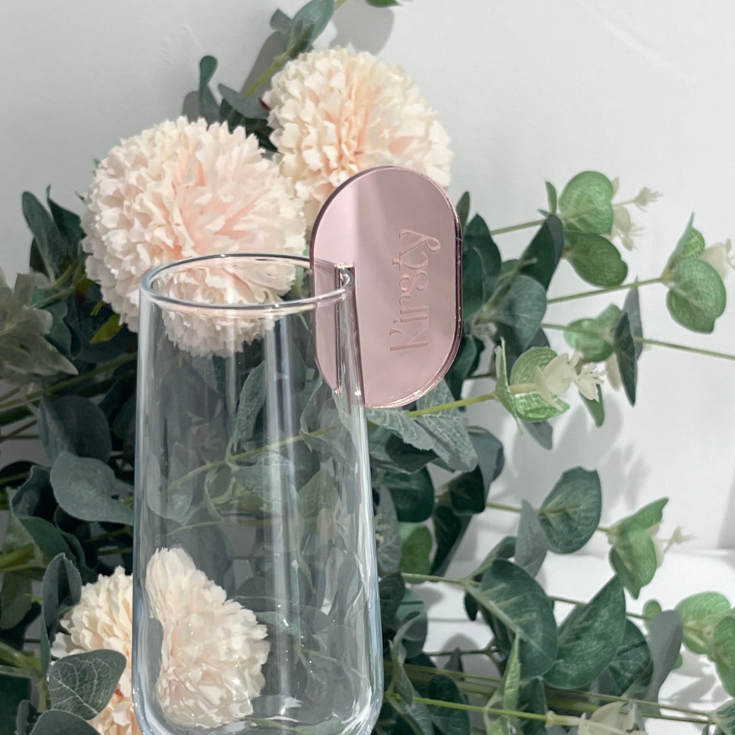 Wedding Place Name that slots on to a wine glass in rose gold mirror acrylic with the name Kirsty engraved in to it