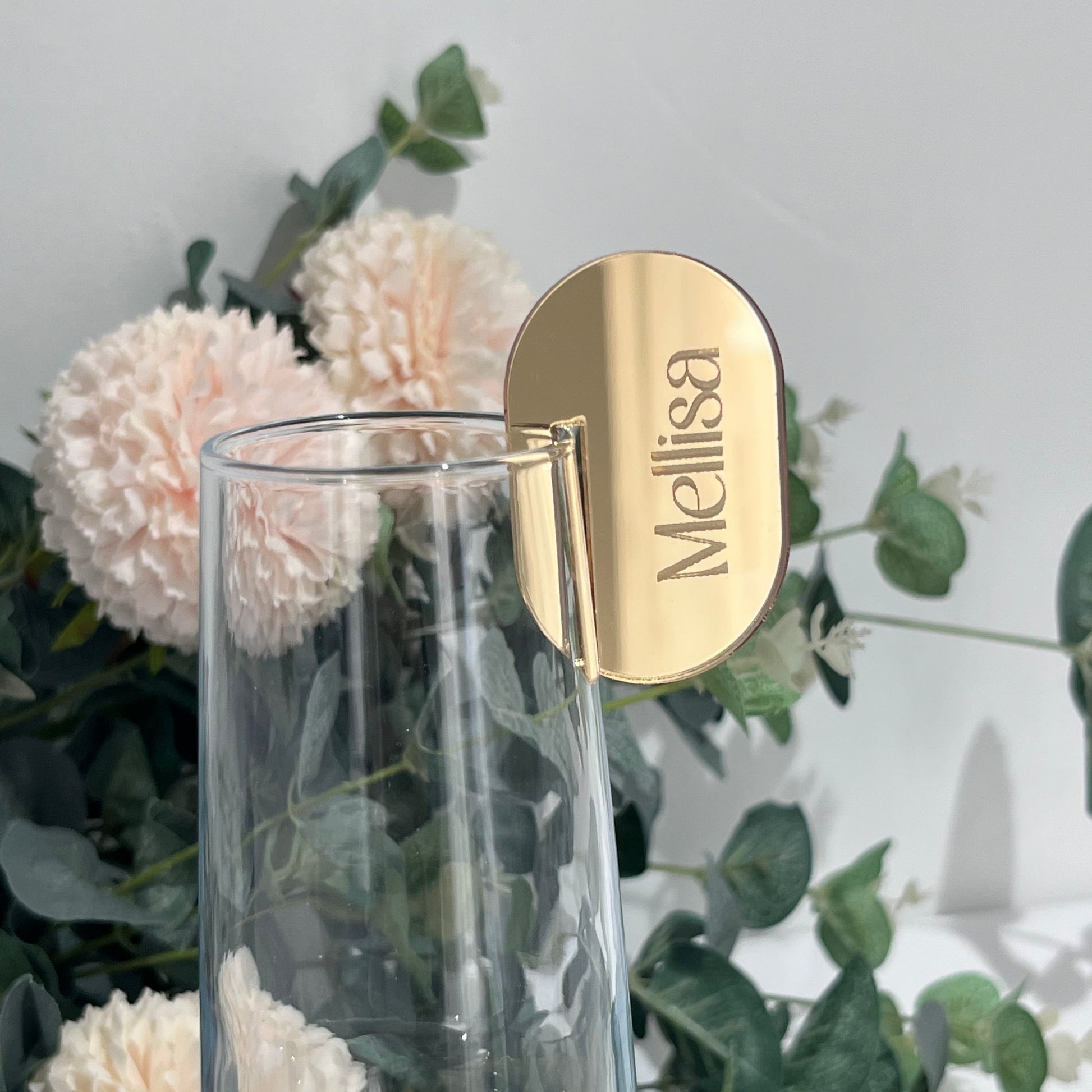 Wedding Place Card that slots on to a wine glass in gold mirror acrylic with the name Melissa engraved in to it