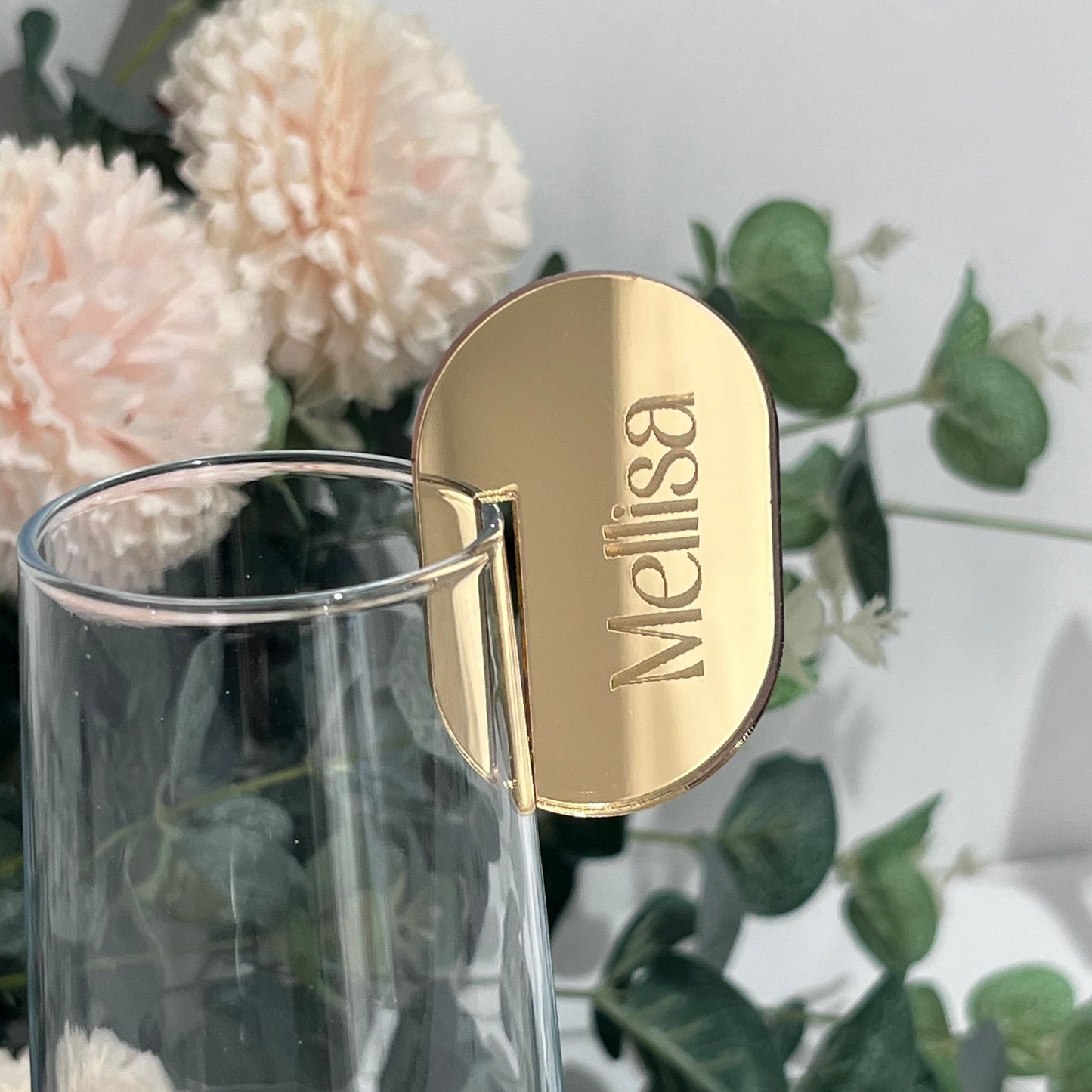Wedding Place Name that slots on to a wine glass in gold mirror acrylic with the name Melissa engraved in to it